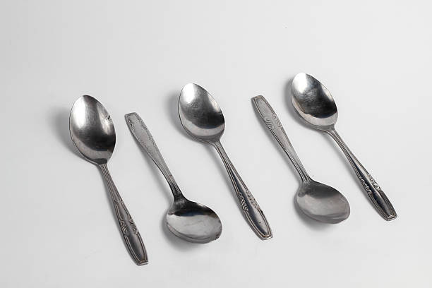 istock Bunch of iron spoons isolated on white background.interior home appliances 2220484598
