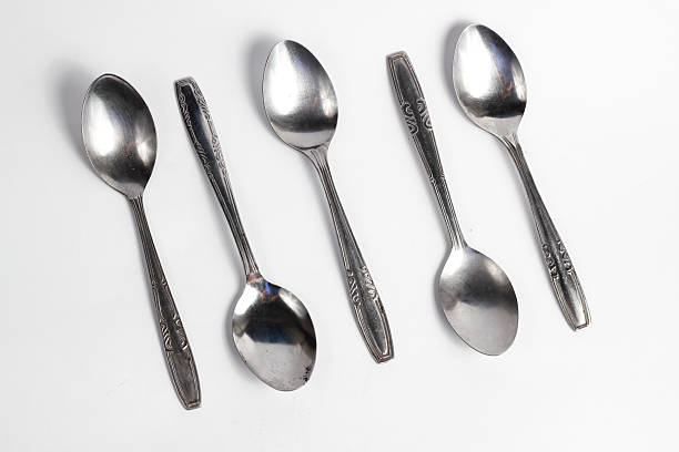 istock Bunch of iron spoons isolated on white background.interior home appliances 2220484609