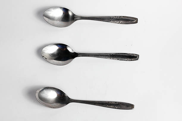 istock Bunch of iron spoons isolated on white background.interior home appliances 2220484615