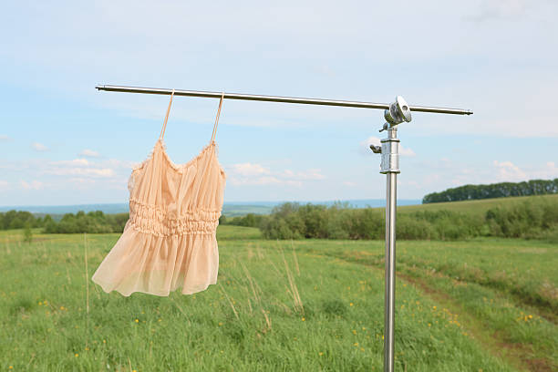 istock Elegant summer dress hanging outdoors on a clothesline 2220491219