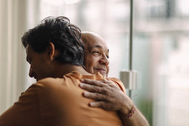 istock Latino men hugging at home 2220493259