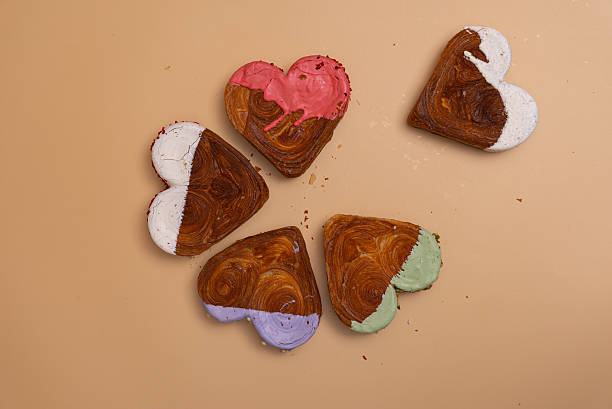 istock Creative ides Valentine's Day flat lay top view Holiday celebration Heart shaped different variety flavor croissants on beige background with copy space. Puff pastry new trendy sweet dessert bakery. Creamy dough 2220493613
