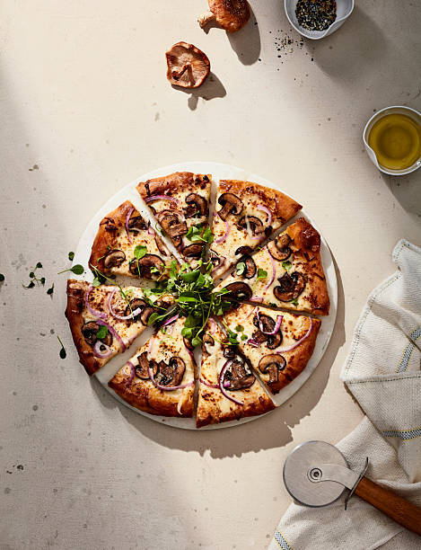 istock Mushroom and Onion Pizza with Herbs on Rustic Table 2220495465