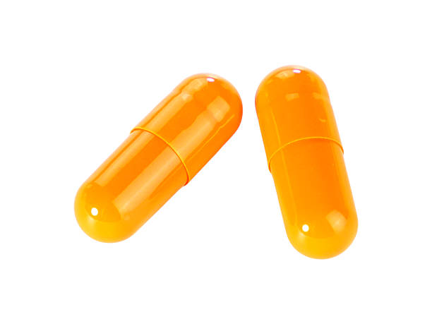 istock Bulk orange capsule pills isolated on white background. 2220496487