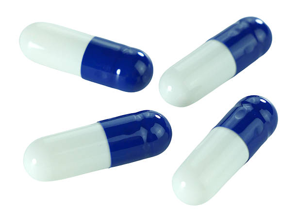 istock Bulk blue and white capsule pills isolated on white background. 2220496495