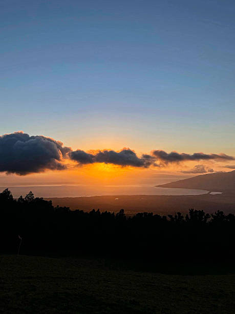 istock Sunset Through the Clouds Over Maui Ocean 2220497363