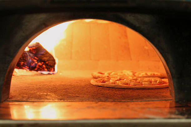 istock Pizza Dough Cooking in Italian Pizza Oven 2220501709