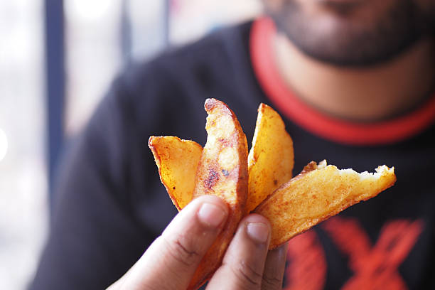 crispy fries in shallow white bowl, even golden color with visible salt crystals, overhead studio shot, clean menustyle