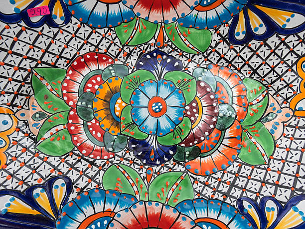 Colorful Talavera crafts showcase intricate floral patterns typical of Mexican artistry. This traditional ceramic technique, rooted in colonial history, reflects vibrant hues of blue, green, red, and yellow.