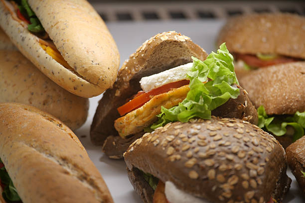 Various sandwiches are arranged showcasing fresh ingredients and breads.