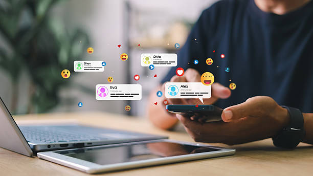 istock Man using smartphone with floating social media message notifications and emoji reactions. Concept of digital communication, social engagement, and real-time interaction. 2220506736