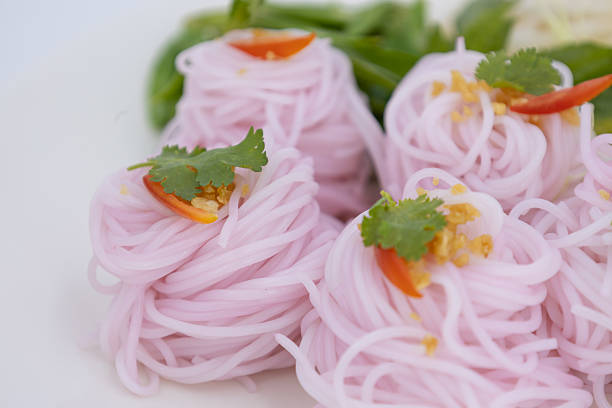 Kanom Jeen Sao Nam, Thai food, Traditional Thai rice noodles beautifully arranged with fresh vegetables and herbs on white background