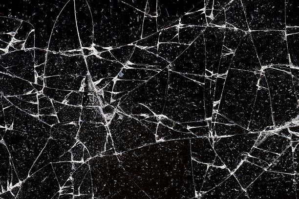 istock broken glass on a black background, thin glass broken into pieces, close up 2220509659
