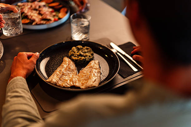 istock Fine Dining Experience with Delicious Grilled Fish and Sides 2220510002