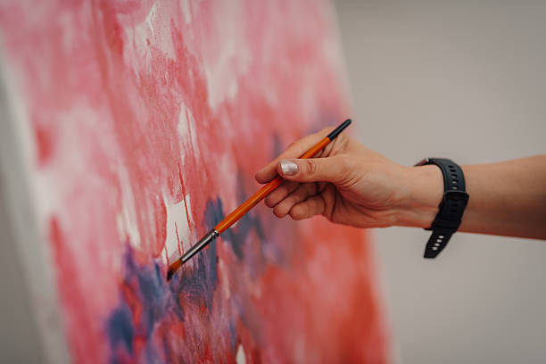 istock Artist painting abstract modern art on canvas using brush 2220512280