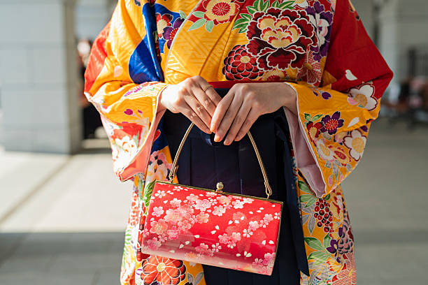 A young European woman wearing a Kimono exploring the Asakusa area of Tokyo Japan at night.