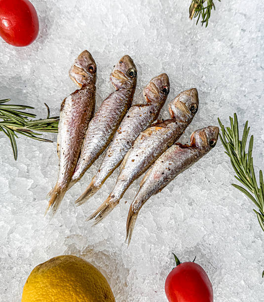istock A close up of five fish on a plate with a lemon and a tomato 2220517876