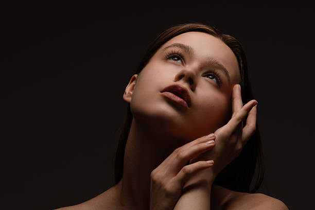 istock Portrait of a Woman in Dramatic Lighting Pose 2220528041