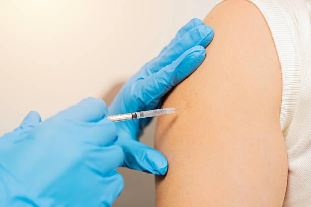 istock Close up of nurse hands getting vaccinated with syringe and needle. 2220532151