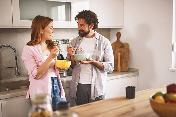 istock Couple eating breakfast together in modern kitchen 2220537515