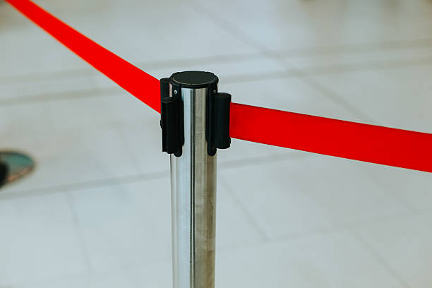 istock Border tape for queues, Focus barricade, stainless pole and red 2220539544