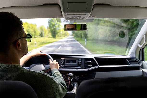 istock Adjusting mirror. Spring car travel. Interior driving view. 2220539580