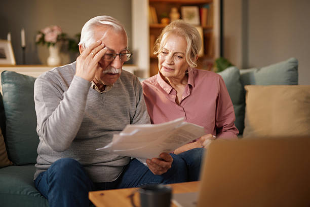 istock Senior couple worried while reading documents about life insurance 2220542175