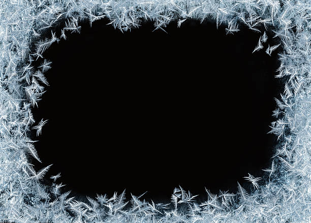 istock Beautiful blue frost patterns arranged as frame on black background with clipping paths. Symbol of Christmas wonder. 2220542583