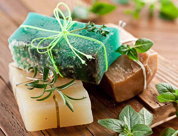 istock Handmade natural soaps tied with rustic strings on wooden table, View above. 2220542993