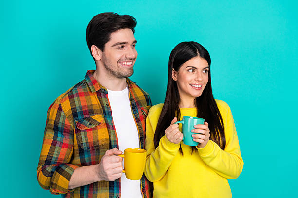 Loving couple spending leisure time together while drinking coffee outdoors