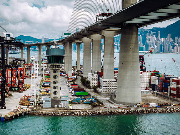 Dynamic Hong Kong scene featuring Stonecutters Bridge, nearby cargo operations, and a vibrant skyline.