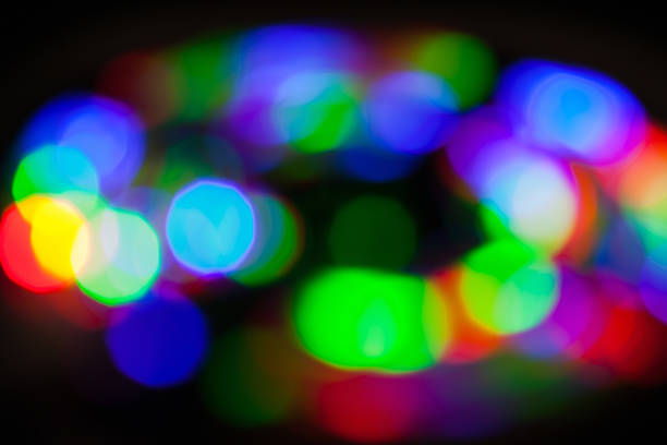 Brightly colored circular bokeh lights create a vibrant and engaging abstract effect, ideal for festive or creative concepts such as holiday decorations or modern artistic applications. Blurred photo