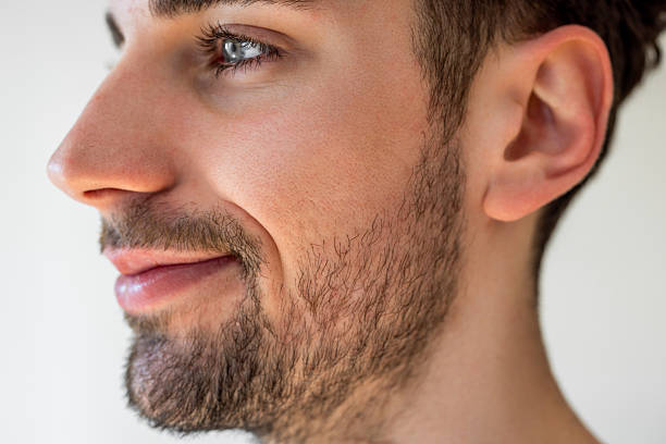 Side view close-up of a handsome male with beard looking away