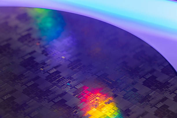 istock Macro Shot of a Silicon Wafer during Semiconductor. Silicon Wafers with microchips used in electronics for the fabrication of integrated circuits 2220548578