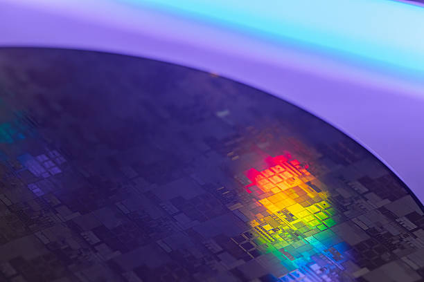 istock Macro Shot of a Silicon Wafer during Semiconductor. Silicon Wafers with microchips used in electronics for the fabrication of integrated circuits 2220548592