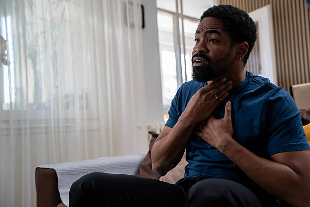 istock Unhappy Black man using his hand touching on his neck Suffering From Gland Inflammation 2220549036