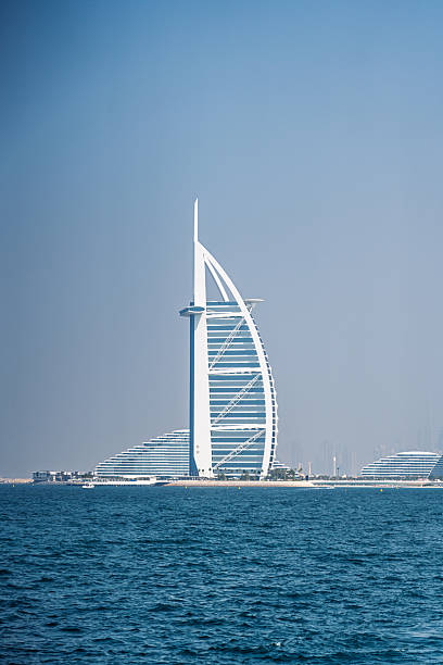 Dubai, United Arab Emirates - May 12, 2024: The iconic Burj Al Arab hotel seen from the tranquil waters of the Arabian Gulf