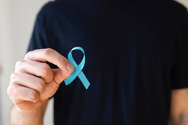 istock Male holding blue ribbon for awareness 2220551396