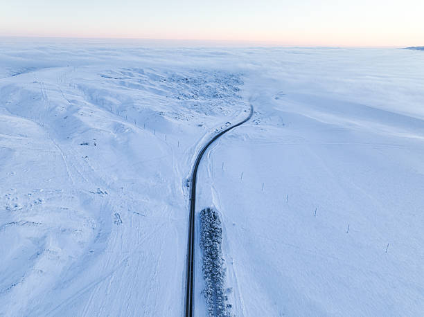 istock Winding road through a snow-covered valley 2220551497