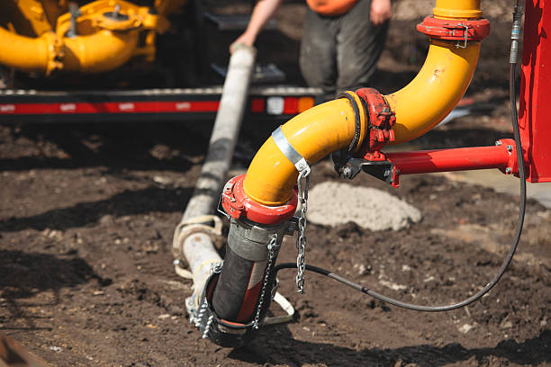 istock Close-up of mobile concrete pump pipes on construction site 2220551914