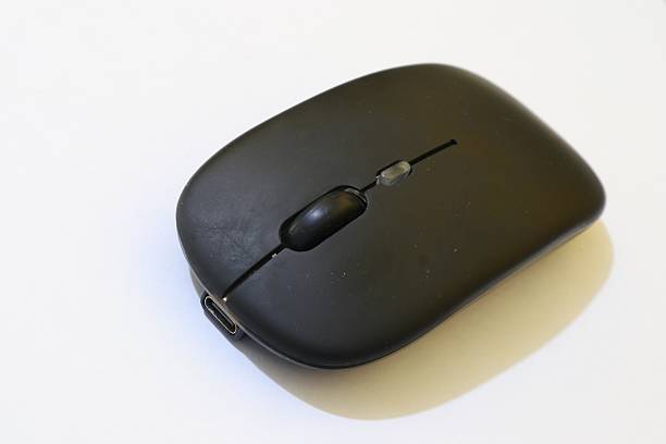 istock Sleek Wireless Mouse in Matte Black Finish Enhancing Technological Sophistication and Practicality on a Bright White Background 2220554033