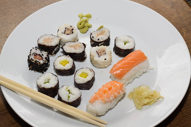 istock different types of sushi, served on a white place with chopsticks, 2220555669