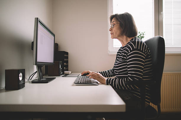 istock Elderly woman works freelance online 2220560708