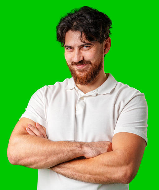 istock A man with a beard smiles confidently against a bright green background 2220561550
