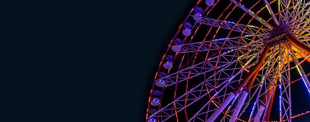 istock Colorful Ferris Wheel Lights at Night banner background 2220561973