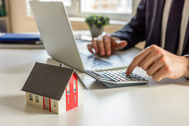 istock Man calculating for house sales 2220562041