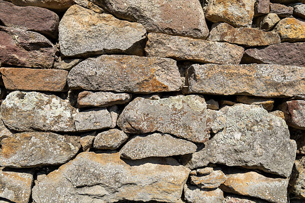 istock Closeup of rustic stone wall texture 2220562234