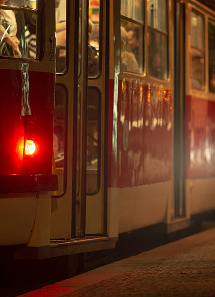 istock A red and white bus is parked at a train station during the night 2220563156