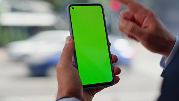 istock Man hands touching green screen smartphone big window closeup. Unknown director 2220563293
