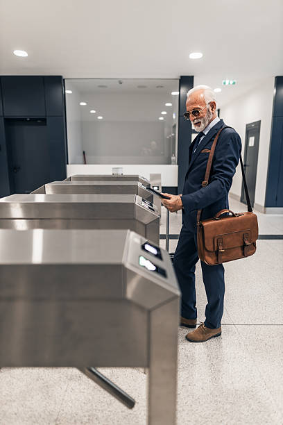 istock Businessman Using Turnstile in Office Building Area with Suit and Bag 2220563651